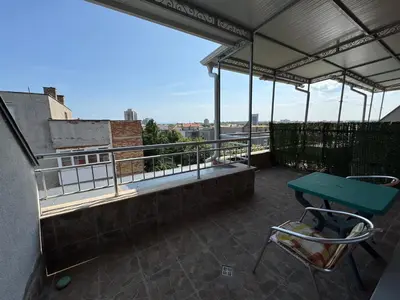 a patio with a green table and chairs on a roof at VP Palazzo Nesebar in Nesebar