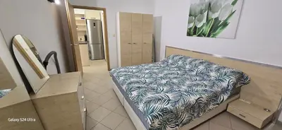 a room with a bench with a blanket on it at Sunny Beach Blue Perl in Sunny Beach