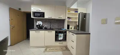 a kitchen with a stove and a refrigerator at Sunny Beach Blue Perl in Sunny Beach