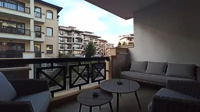 a balcony with couches and tables on a building at Premium Oasis Beach Club Apartment in Lozenets