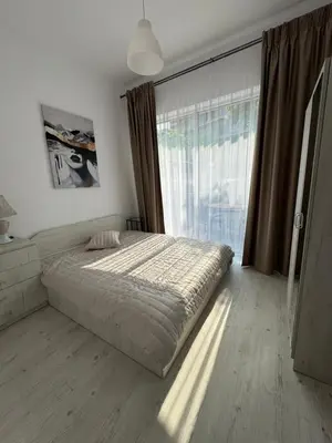 a bedroom with a bed and a large window at Luxury seaside apartment with seaview in Sveti Vlas