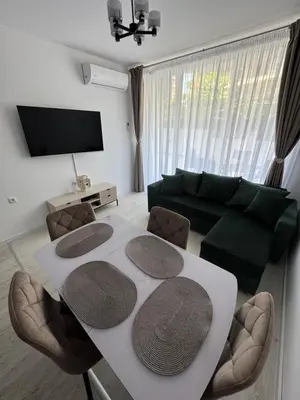 a living room with a table and a couch at Grand Villa luxury apartment with sea view in Sveti Vlas