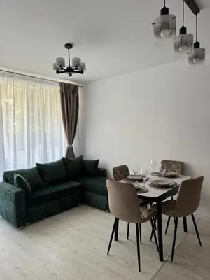 a living room with a green couch and a table at Grand Villa luxury apartment with sea view in Sveti Vlas