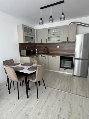 a kitchen with a table and chairs and a refrigerator at Grand Villa luxury apartment with sea view in Sveti Vlas