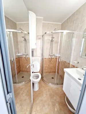 a bathroom with a shower and a toilet and a sink at Lazur 2 beach apartment in Sveti Vlas