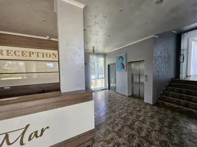 a lobby of a building with a staircase and a sign at Apartman RS in Lozenets