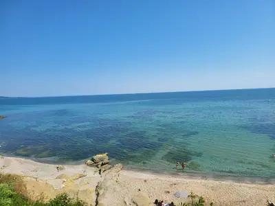 a view of the ocean with people in the water at Apartman RS in Lozenets