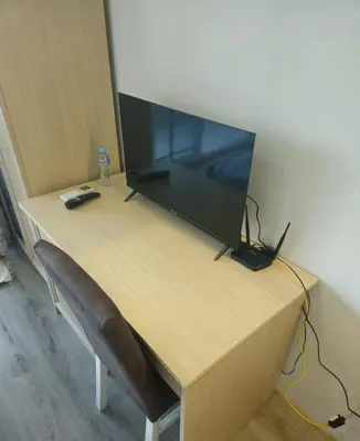 a wooden desk with a television on top of it at Apartman RS in Lozenets