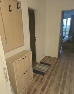 a room with a dresser and a mirror and a hallway at Apartman RS in Lozenets