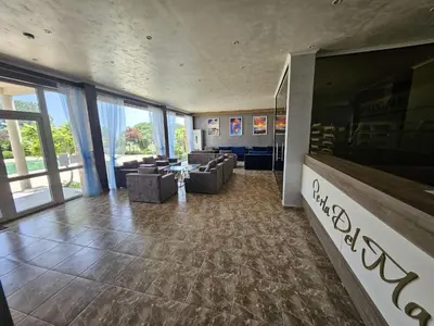 a lobby with couches and chairs in a building at Apartman RS in Lozenets