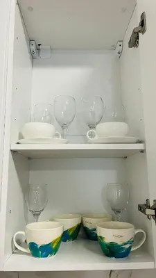 a shelf with bowls and wine glasses on it at ASTORIA II Apartment 12 Sveti Vlas in Elenite