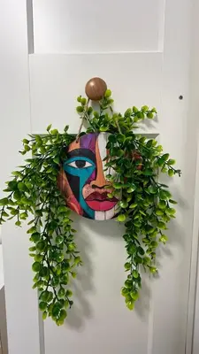 a painting of a woman on a wall with a plant at ASTORIA II Apartment 12 Sveti Vlas in Elenite