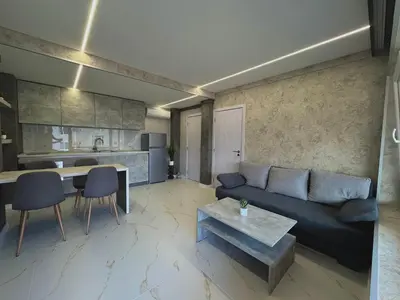 a living room with a couch and a table at Seagull Apartments in Byala