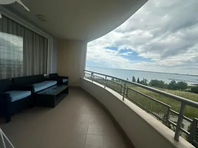 a balcony with a couch and a view of the ocean at Dream holiday Ravda in Ravda