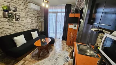 a living room with a couch and a table at Studio 67 & Apartment 16 Rainbow Holiday Complex in Sunny Beach