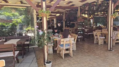a group of people sitting at tables in a restaurant at Studio 67 & Apartment 16 Rainbow Holiday Complex in Sunny Beach
