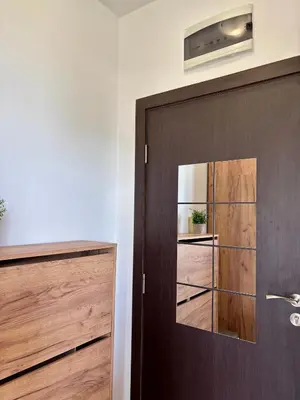 a wooden door with a mirror in a room at Sunset Deluxe in Kosharitsa