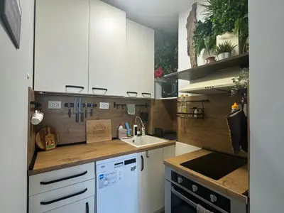 a kitchen with white cabinets and a sink at The Master and Margarita Centre in Burgas City