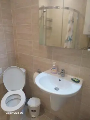 a bathroom with a toilet and a sink at Апартамент Бяла in Byala