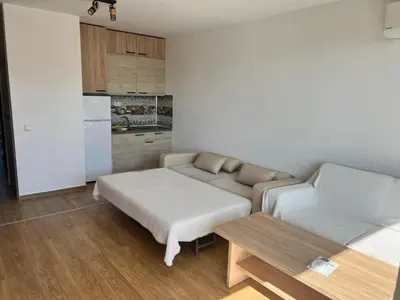a living room with a bed and a couch at Modern Comfort Studio with Terrace Tsarevo in Tsarevo