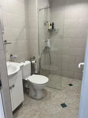 a bathroom with a shower and a toilet and a sink at Modern Comfort Studio with Terrace Tsarevo in Tsarevo