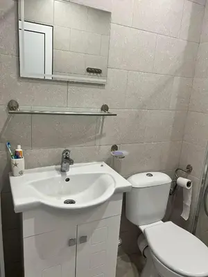 a bathroom with a white sink and a toilet at Modern Comfort Studio with Terrace Tsarevo in Tsarevo