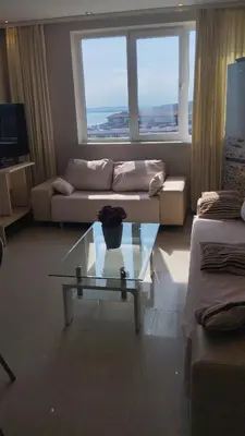 a living room with a couch and a glass table at Yana Privilege apartment Elinite in Elenite