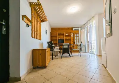 a living room with a table and chairs at Akrotiri 2BR Apartment in Sozopol