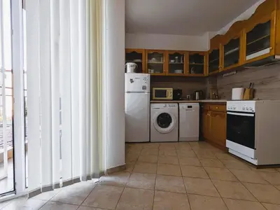 a kitchen with a washing machine and a washer at Akrotiri 2BR Apartment in Sozopol