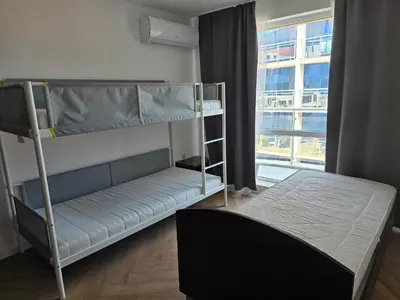 a bedroom with two bunk beds and a window at Izabela in Pomorie