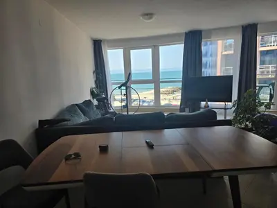 a living room with a table and a couch at Izabela in Pomorie