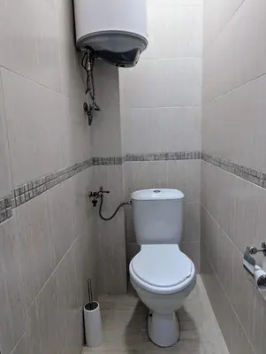 a bathroom with a white toilet in a stall at Apartment Dimanov 1 in Burgas City