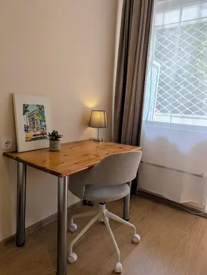 a wooden desk with a chair and a lamp at Apartment Dimanov 1 in Burgas City