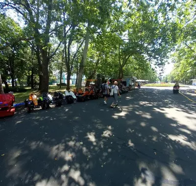 a group of people walking down a street with parked motorcycles at Студио Слънчева перла in Burgas City
