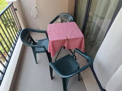 a table and two chairs on a balcony at Апартамент 10 улица Македония 33 in Pomorie