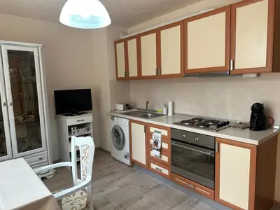 a kitchen with a stove and a sink and a dishwasher at Shishkova Garden Apartments in Varna City