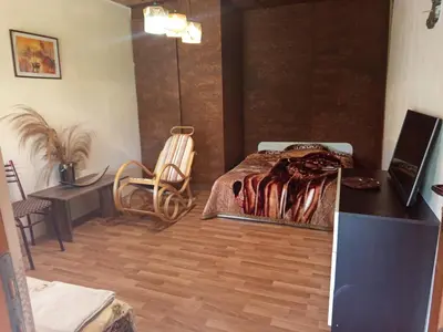 a bedroom with a bed and a desk and a table at Къща за гости Veranda Raia Поморие in Kamenar