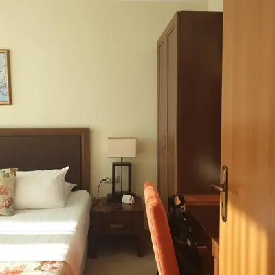 a bedroom with a bed and a table with a lamp at Apartment Sunset resort C4-17 in Pomorie