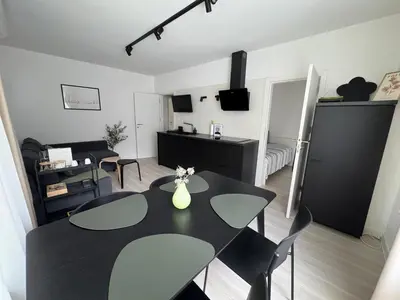 a living room with a black table and chairs at Summer Apartment in Burgas City