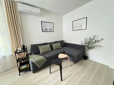 a living room with a couch and a table at Summer Apartment in Burgas City