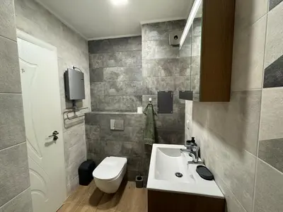 a bathroom with a sink and a toilet at Infinity Apartament in Burgas City