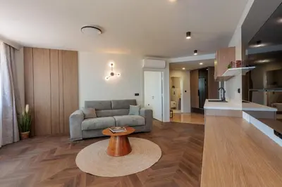a living room with a couch and a table at Hotel Sea Sand in Sveti Vlas
