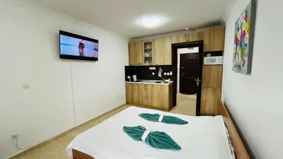 a room with a bed and a tv on a wall at FREGATA STUDIO 4 Sveti Vlas in Sveti Vlas