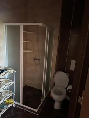 a small bathroom with a toilet and a shower at Центр солнечного берега in Sunny Beach