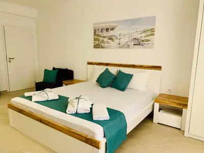 a bedroom with a bed with two towels on it at BAMBOO BEACH STUDIO- Sozopol in Sozopol