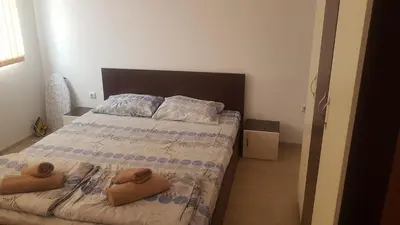 a bedroom with a bed with two towels on it at Villa Victory Apartments in Nesebar