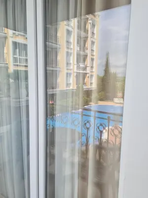 a window with a view of a building at Messembria Palace in Sunny Beach
