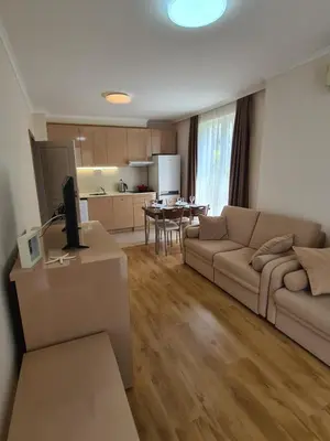 a living room with a couch and a table at Messembria Palace in Sunny Beach