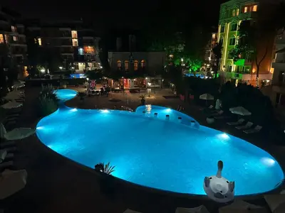 a large swimming pool at night in a city at Kalia A7 Sunny Beach in Bŭnzareto