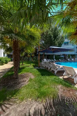 a group of lounge chairs next to a swimming pool at Apartment D9 Yassen HV in Sunny Beach